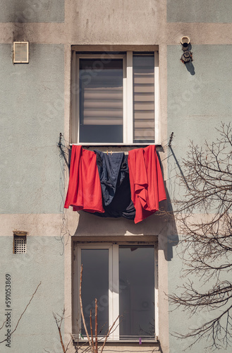 Old worn out communist apartment building in Bucharest, Romania. Old clothes laundry left to dry on the balcony.