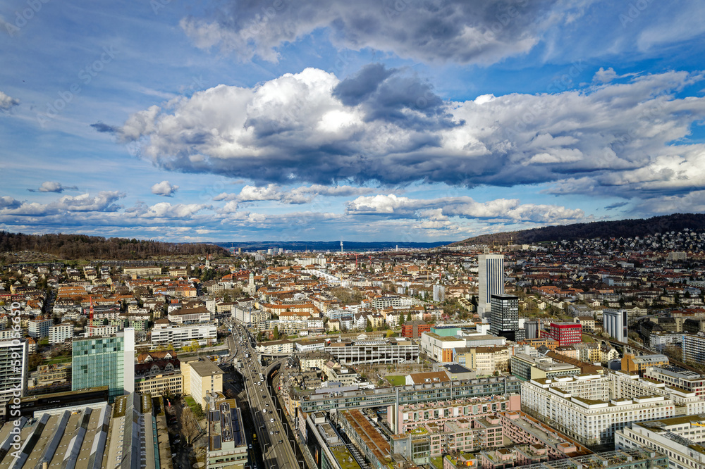 Aerial view of City of Zürich with industrial district on a blue cloudy late winter day. Photo taken March 15th, 2023, Zurich, Switzerland.