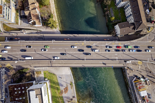 Top view of City of Zürich with Limmat River and Hard Bridge and heavy traffic on a blue cloudy late winter day. Photo taken March 15th, 2023, Zurich, Switzerland.