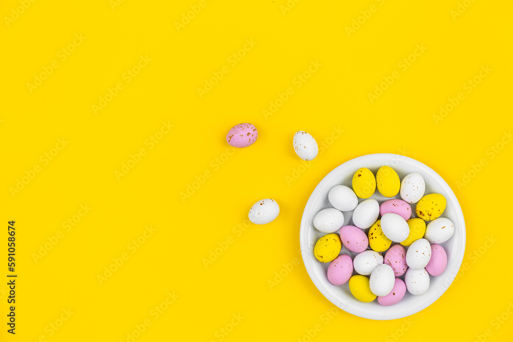 Plate with Easter eggs on a yellow background, top view. Plate with Easter eggs on a yellow background, top view.