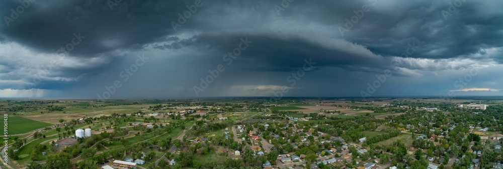 Aerial panoramic shot of a small village on a field on a cloudy day Aerial panoramic shot of a small village on a field on a cloudy day