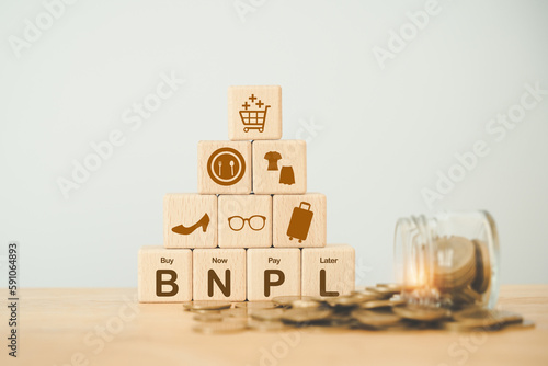 Fotografie wood block with icon BNPL with online shopping icons blurred coins