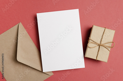Paper greeting card mockup with envelope and gift box, top view with copy space