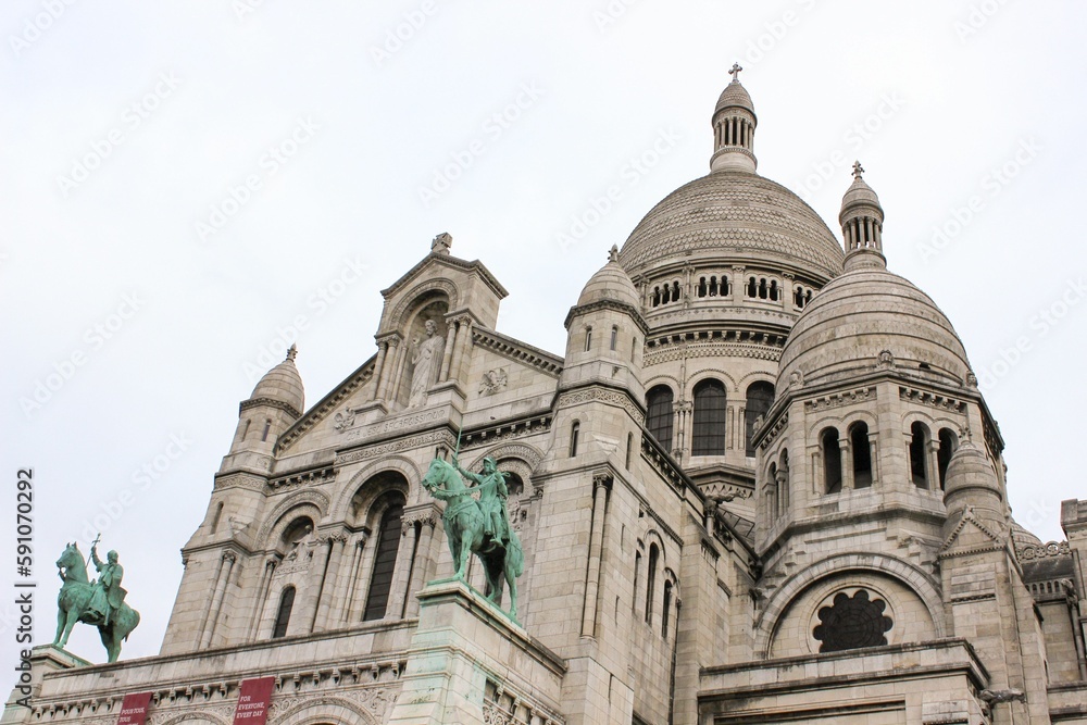 Low angle shot of the Sacre-Coeur Basilica against white sky in Paris, France