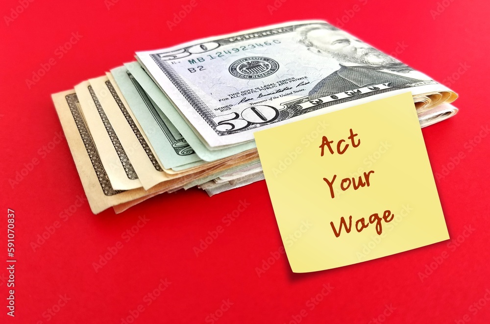 Cash money on red background with stick note written ACT YOUR WAGE, viral workplace trend which employees respectfully decline tasks that not paid or financially compensated for Cash money on red background with stick note written ACT YOUR WAGE, viral workplace trend which employees respectfully decline tasks that not paid or financially compensated for