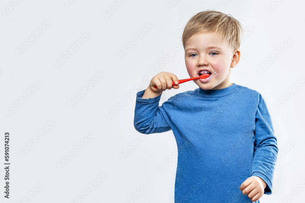 A small boy brushes his teeth on his own. A small boy brushes his teeth on his own.