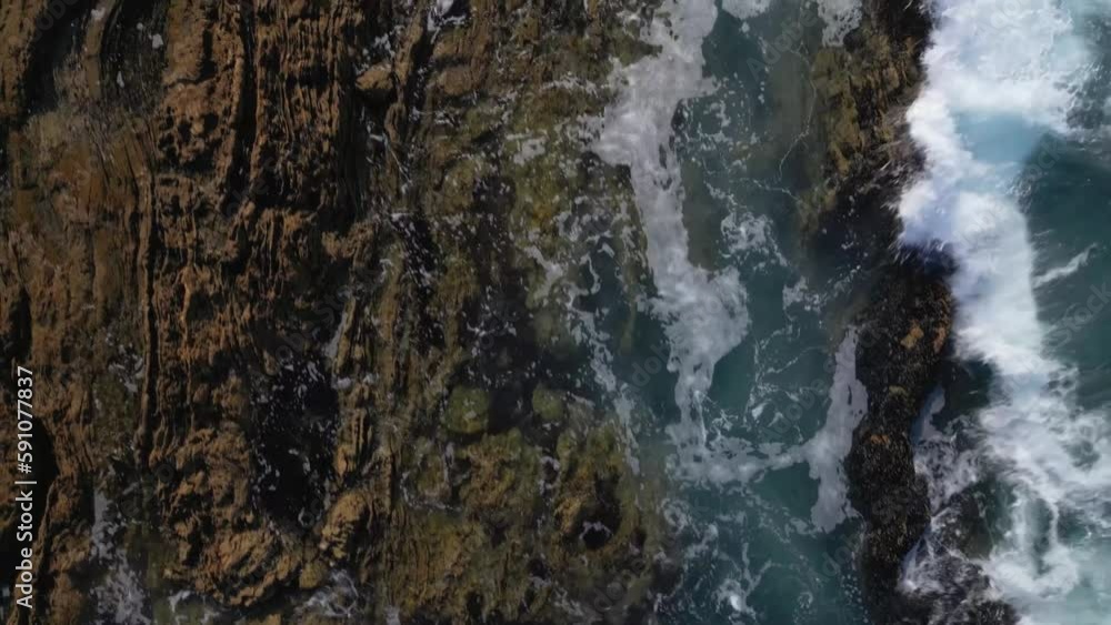 Rocky shoreline with gentle waves seen from a drone. Newport Beach, California. Rocky shoreline with gentle waves seen from a drone. Newport Beach, California.