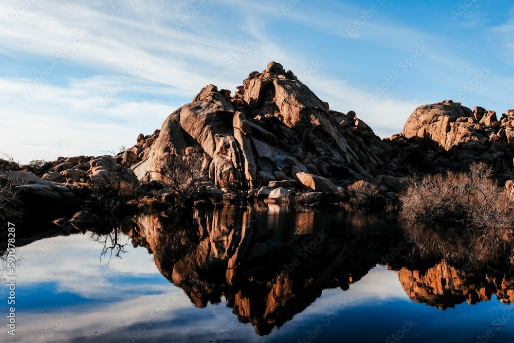 View of a rocky cliff and the reflection on the lake