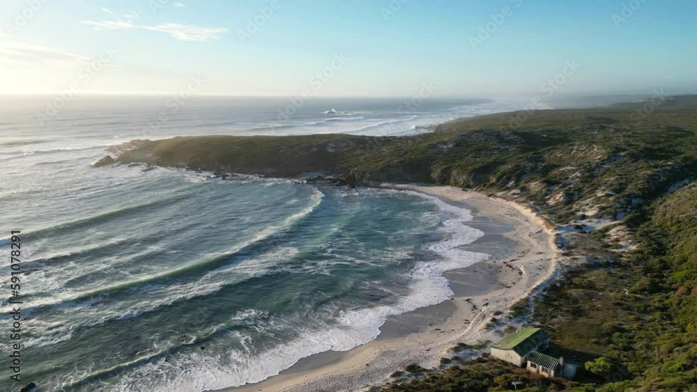 4k drone flying over beach with ocean waves and green mountain at sunset 4k drone flying over beach with ocean waves and green mountain at sunset