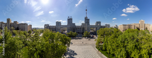 Aerial view on Derzhprom and Karazin National University buildings on green Freedom Square with blue sunny sky in Kharkiv, Ukraine photo