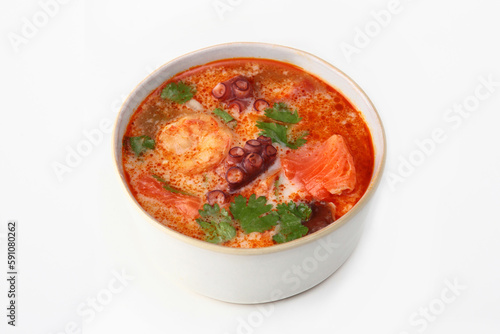 Spicy soup with octopus and shrimp. Thai cuisine. Tom Yam Kung soup on a white background.Copy space.