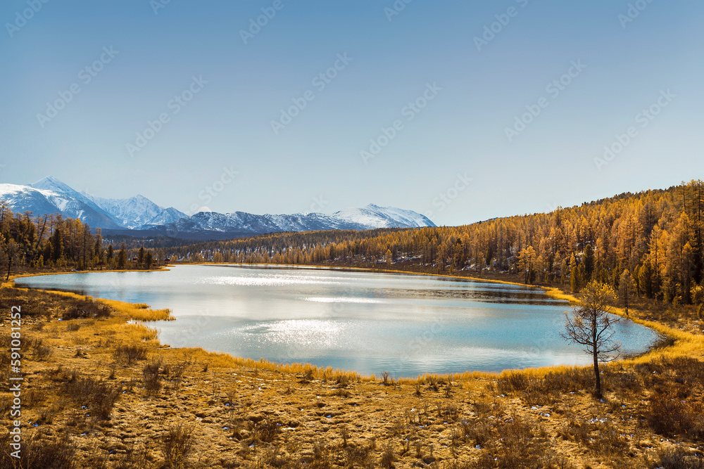Top view of lake Kidelu against the background of snow-capped peaks of the Kurai range. Ulagansky District, Altai Republic, Russia