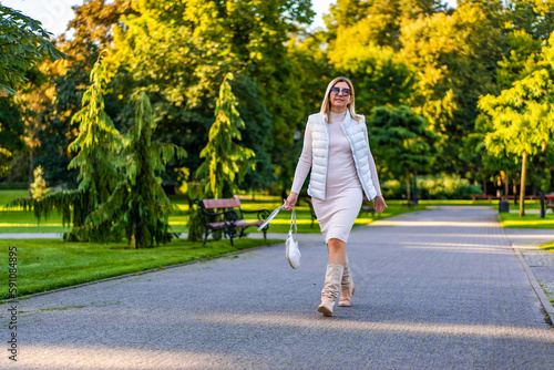 Beautiful woman walking in city park  © Jacek Chabraszewski