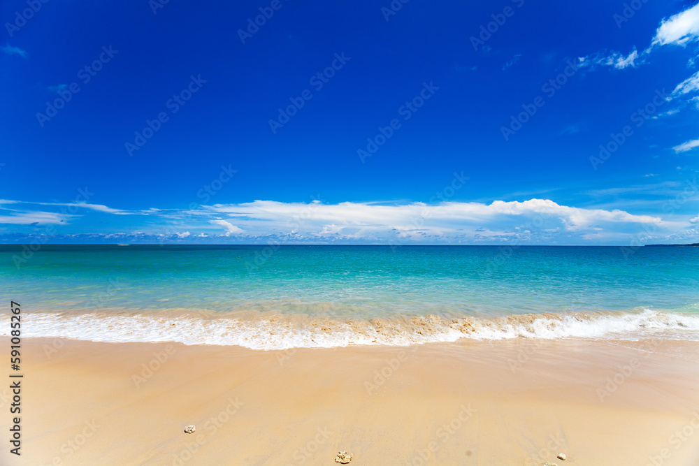 Sandy beach and beautiful tropical sea with blue sky.