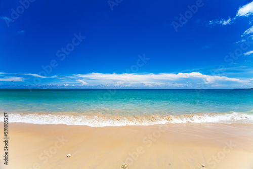 Sandy beach and beautiful tropical sea with blue sky.