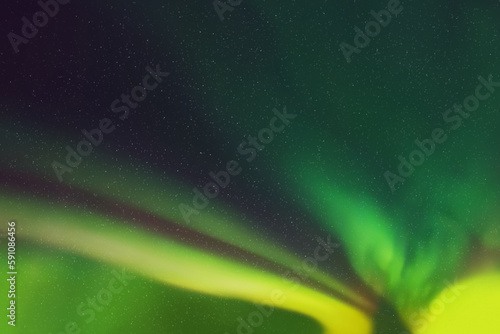 Green aurora borealis. Dark night starry sky and Northern lights
