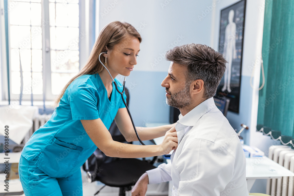 Caring Caucasian female doctor use phonendoscope examine male patient heart rate at consultation in hospital. Woman nurse or GP use stethoscope listen to man heartbeat in clinic. Caring Caucasian female doctor use phonendoscope examine male patient heart rate at consultation in hospital. Woman nurse or GP use stethoscope listen to man heartbeat in clinic.