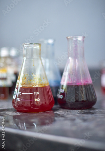 Chemical dye equipment and beakers in a fabric and industrial colouring cotton labratory factory. Dying fabrics for the fashion industry. Glass beakers and bottles.