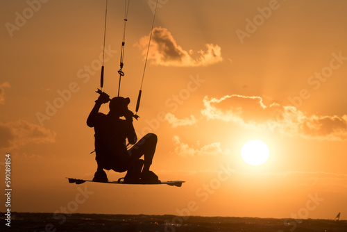 Kiten, kite surfing at sunset in the baltic sea photo