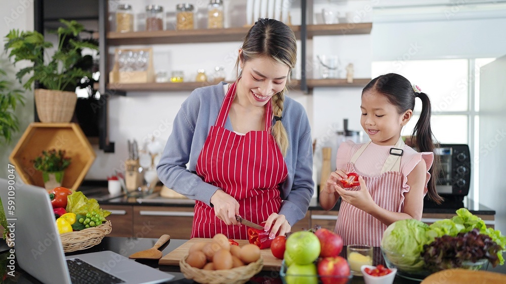 Asian family, mother and daughter enjoy cooking vegetable spending time together in kitchen room at home. Healthy meal and dinner, happy family asian concept
