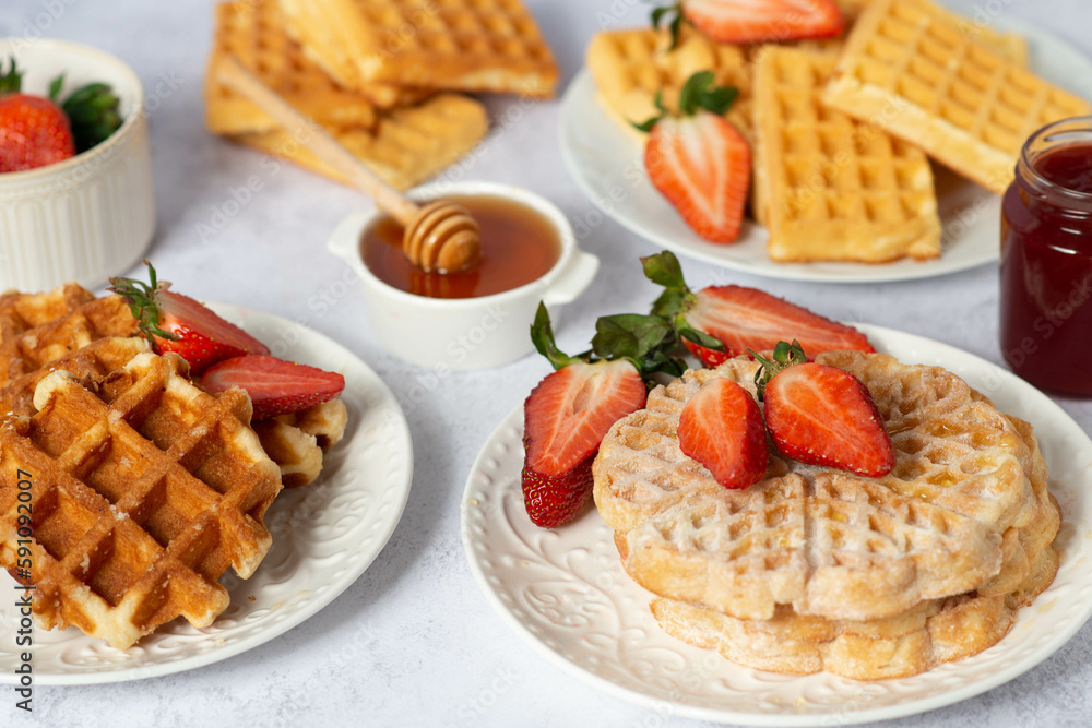 Traditional belgian waffles with fresh fruit and caramel on white background. Traditional belgian waffles with fresh fruit and caramel on white background.