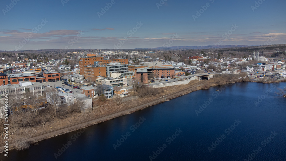 Aerial view of part of the city of Magog in Quebec, Canada, with its river.