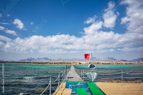 Sunny beach with long Bridge on the coast of Sharm El Sheikh, Egypt