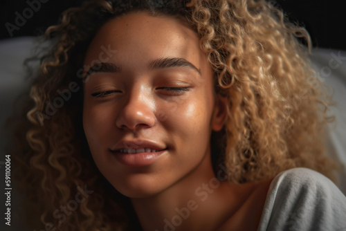 Smiling Young Woman Relaxing Indoors at Night © Nedrofly