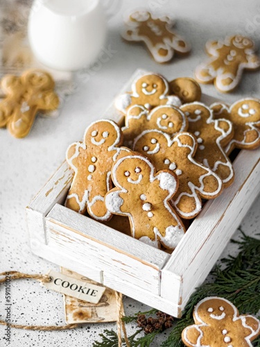 Vertical shot of a wooden box with homemade cute Christmas gingerbread cookies