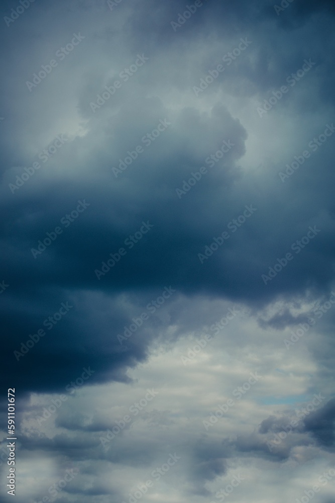 Vertical shot of large clouds in a dark stormy sky