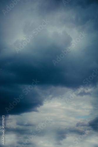 Vertical shot of large clouds in a dark stormy sky