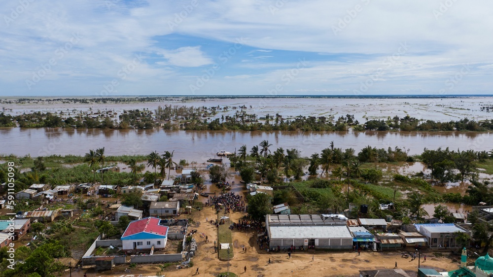 Big flood with trees and a village in the dirty waters in Africa