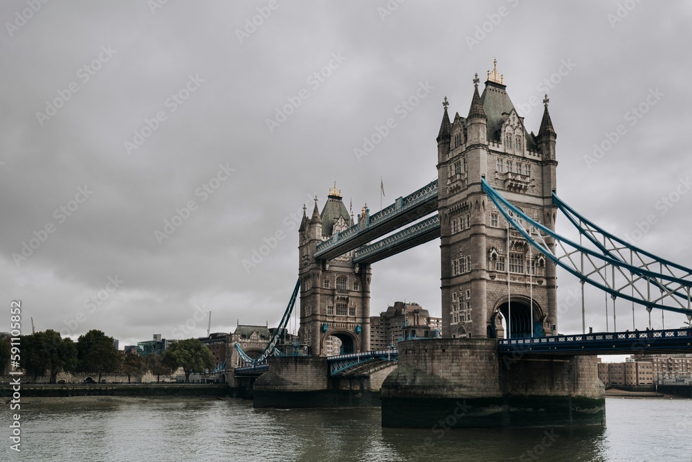 Low angle shot of the Tower Bridge in London over the River Thames in cloudy weather