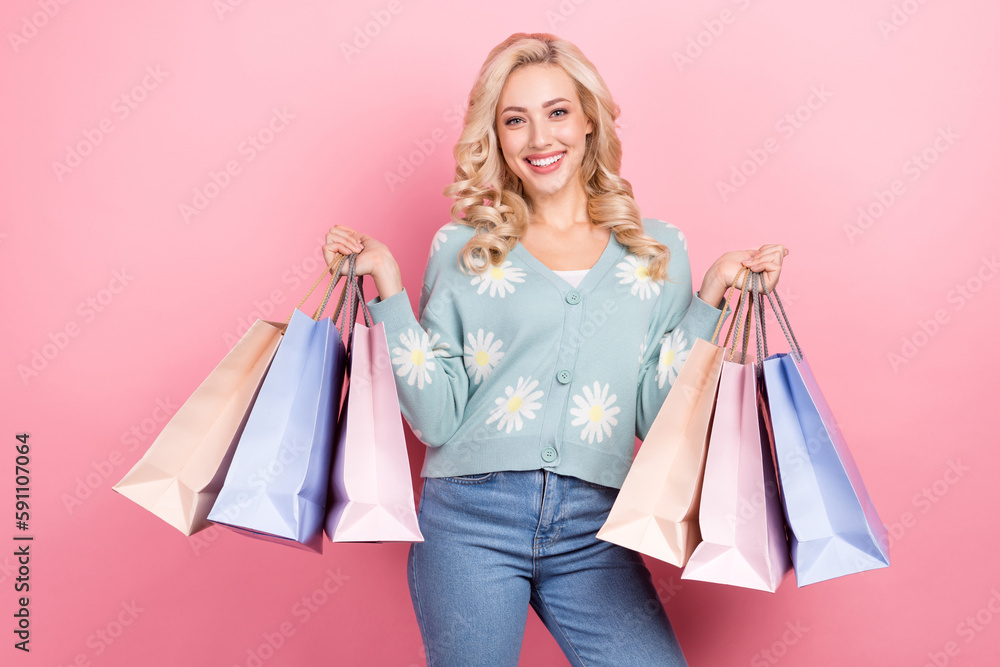 Photo of positive stunning person toothy smile hands hold shopping bags isolated on pink color background Photo of positive stunning person toothy smile hands hold shopping bags isolated on pink color background
