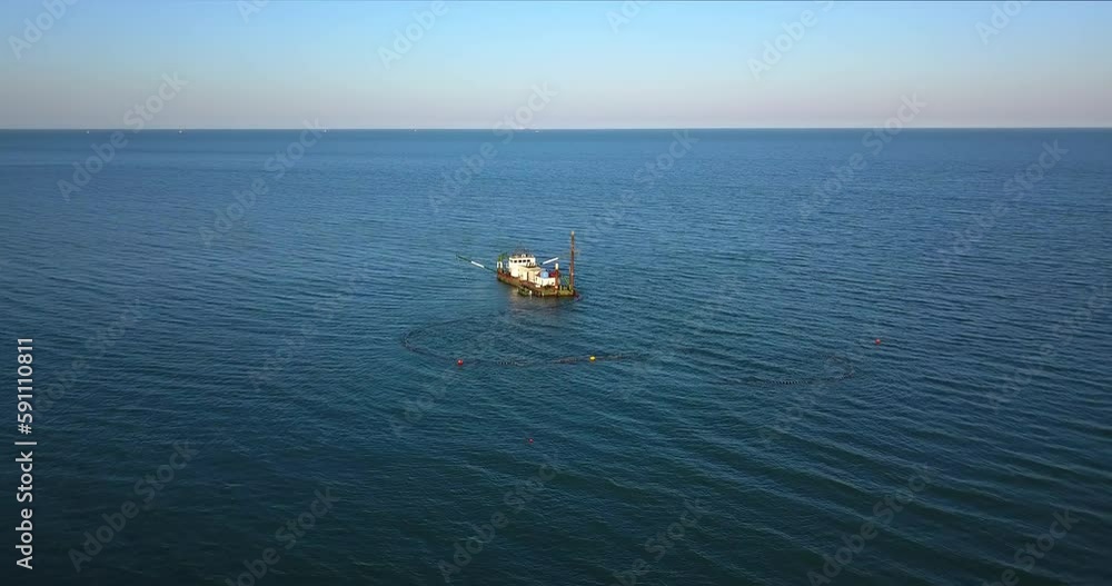 A boat is doing some work in the middle of the sea A boat is doing some work in the middle of the sea