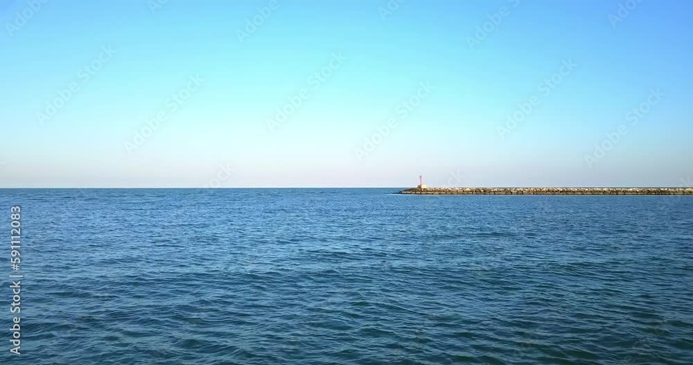 Low overflight above the sea surface and a dike Low overflight above the sea surface and a dike