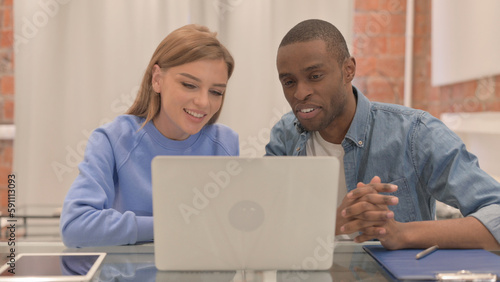 Online Video Chat by Interracial Couple on Laptop  © stockbakers