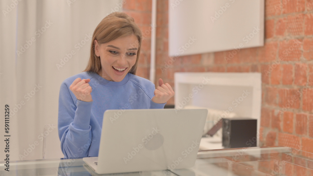 Excited Young Woman Celebrating Success on Laptop Excited Young Woman Celebrating Success on Laptop