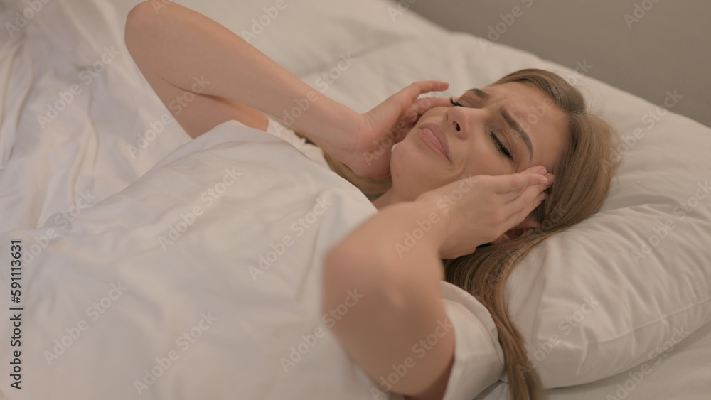 Young Woman with Headache Lying in Bed Young Woman with Headache Lying in Bed