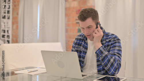 Upset Young Casual Man Arguing on Phone Talk