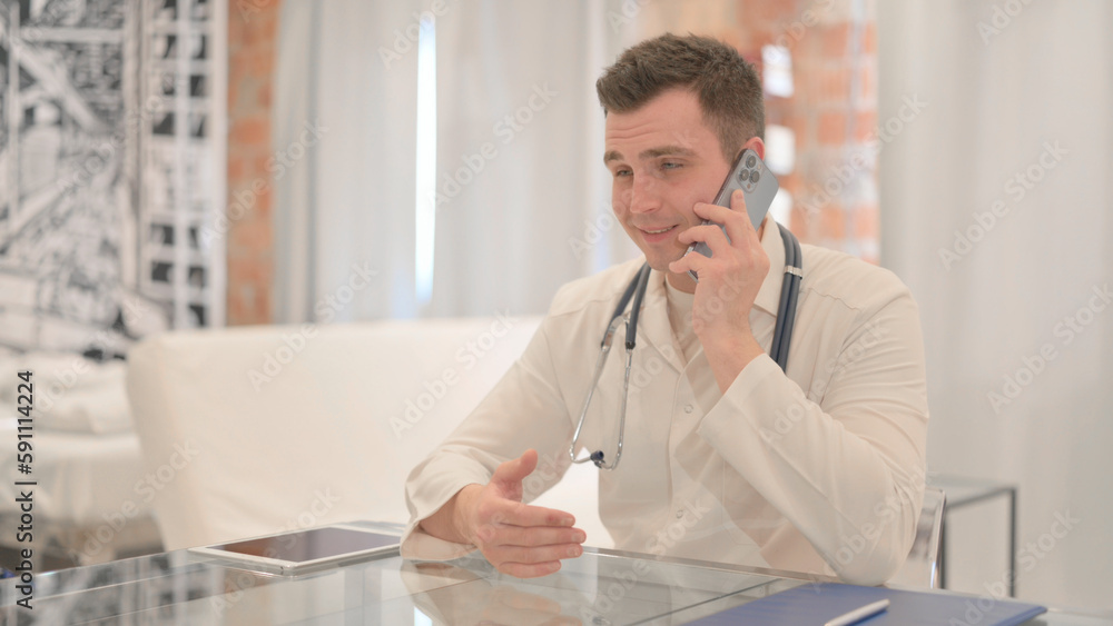 Male Doctor Talking on Phone in Clinic