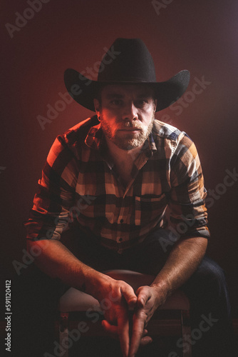 Rugged man in cowboy hat.  Studio session.