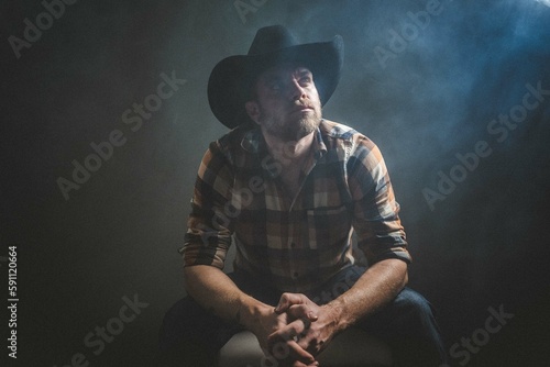 Rugged man in cowboy hat.  Studio session.