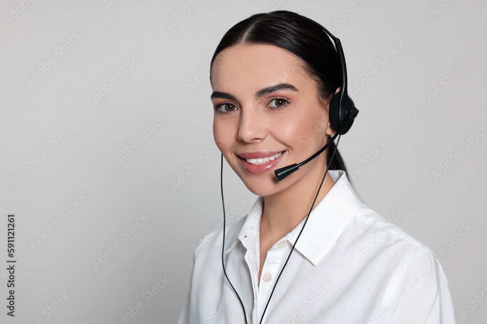 Hotline operator with modern headset on light grey background, space for text. Customer support Hotline operator with modern headset on light grey background, space for text. Customer support