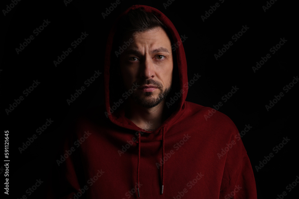 Obraz premium Portrait of sad man on black background
