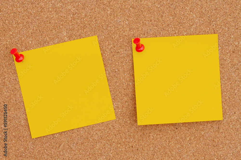 Two blank yellow sticky note on bulletin board Two blank yellow sticky note on bulletin board