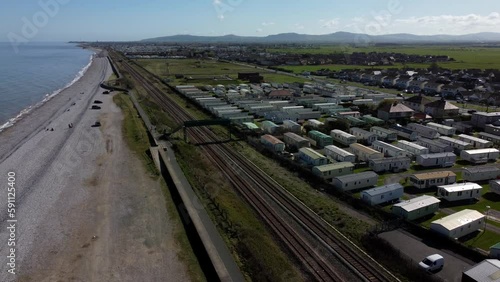 Aerial view orbiting Abergele railway tracks and static caravan park holiday homes in Pensarn beachfront town on the Wales coastal path photo