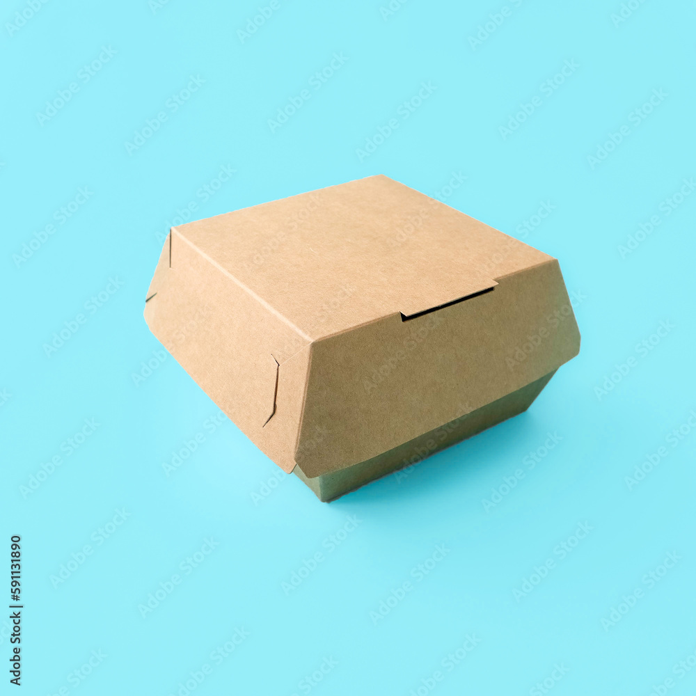 Craft sandwich box on blue background. Place for text and logo. The concept of a single style of the company, branding, packaging, food delivery, eco style.