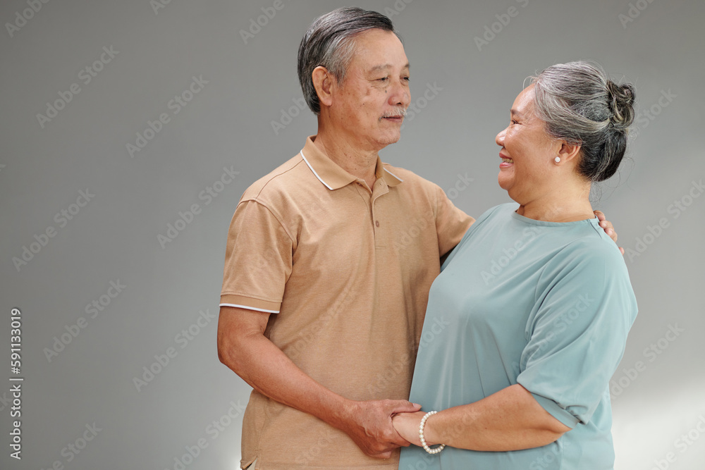 Studio portrait of senior couple dancing and looking at each other Studio portrait of senior couple dancing and looking at each other