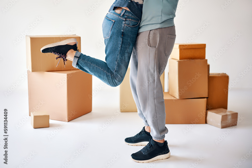 Husband lift wife surrounded by cardboard boxes excited to move in new flat, happy couple have fun hugging and celebrating Husband lift wife surrounded by cardboard boxes excited to move in new flat, happy couple have fun hugging and celebrating
